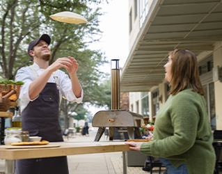 chef tossing pizza dough in the air