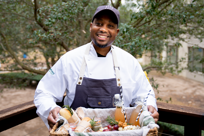 Chef holding a basket of food