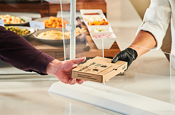 chef handing food to employee