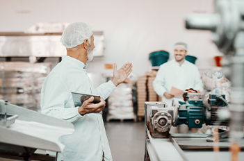 two men in food manufacturing facility
