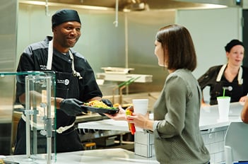 chef serving food to a female customer